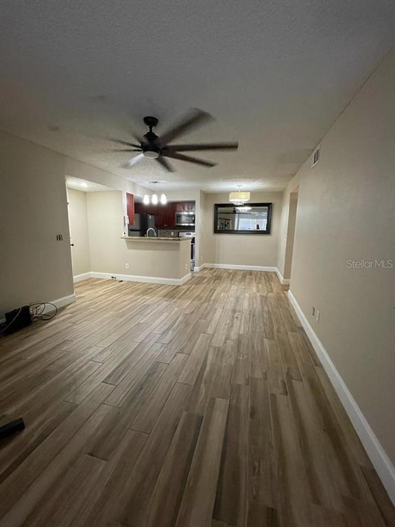 5148 Conroy Road, Unit 18 Orlando, FL 32811 - Photo 8 of 30 a view of a livingroom with wooden floor