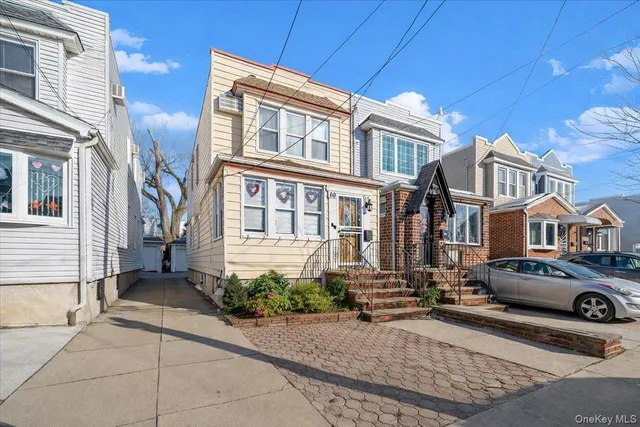 a front view of a residential apartment building with a yard
