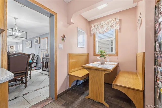 a view of a dining room with furniture and chandelier