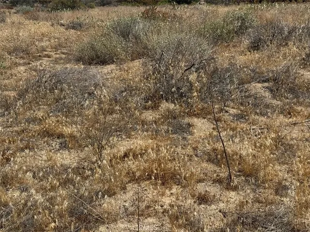 a view of a large mountain with mountains in the background