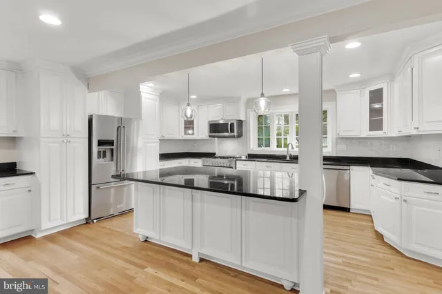 a living room with furniture a rug wooden floor and a fireplace