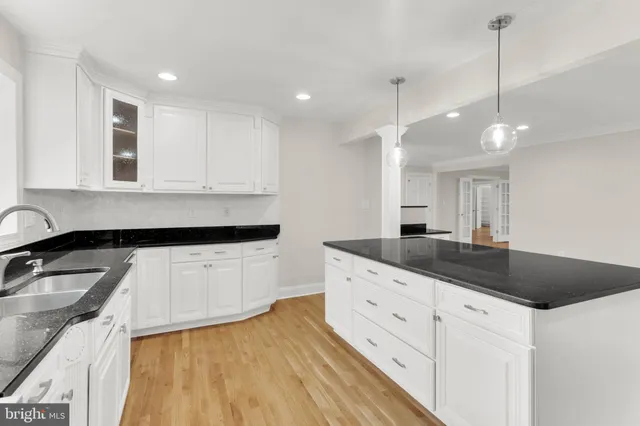 a living room with furniture flat screen tv and a large window