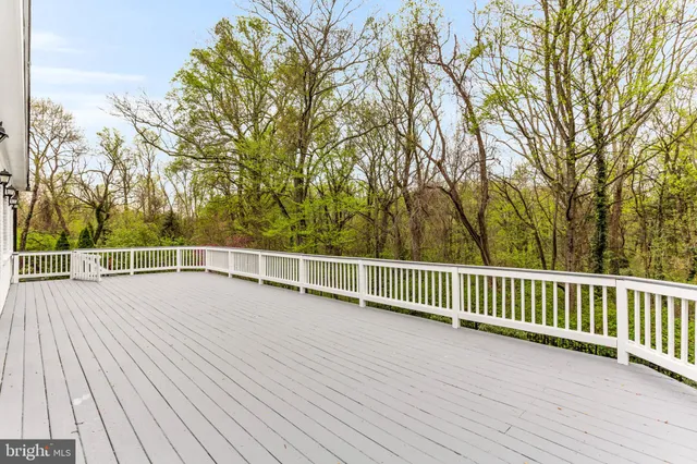 a view of empty room with wooden floor and windows