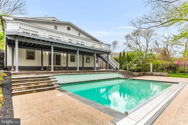 a view of a kitchen with kitchen island wooden floor and a fireplace