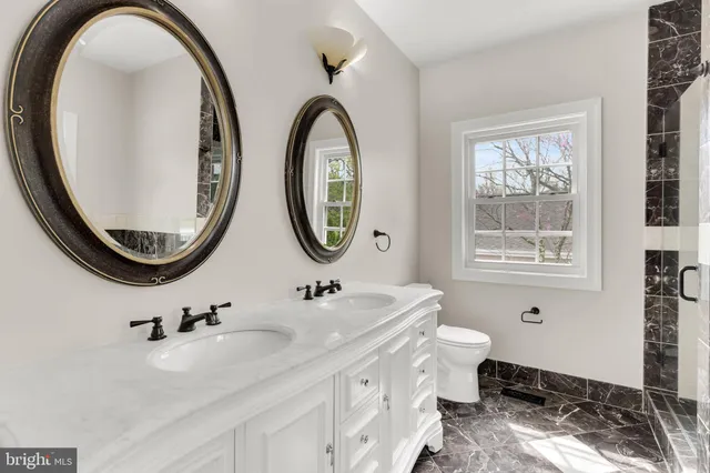 a bathroom with a sink toilet and mirror