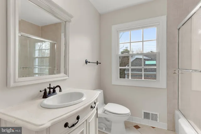 a bathroom with double sink and a mirror