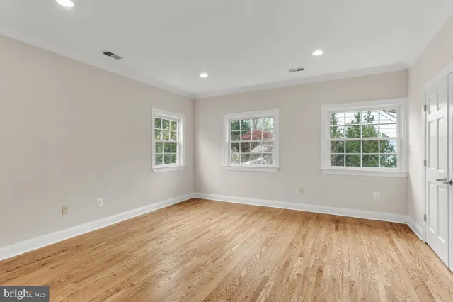 a view of an empty room with a fireplace and a window