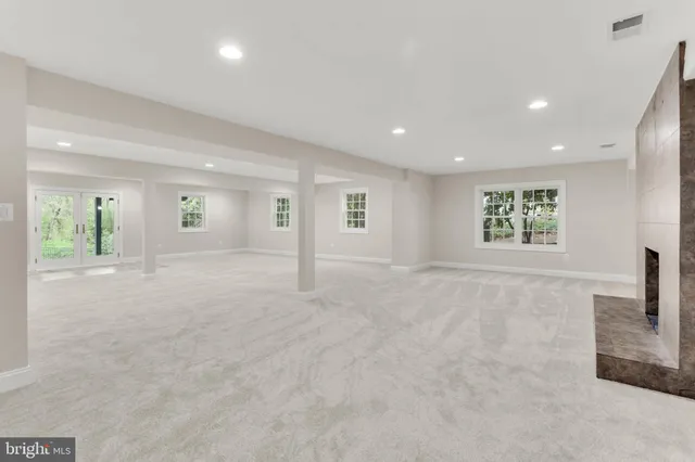 a bathroom with a granite countertop sink a mirror and a shower