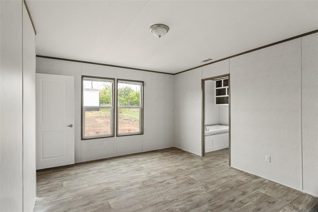 3606 Hilltop Road Granbury, TX 76048 - Photo 16 of 25 an empty room with windows and closet