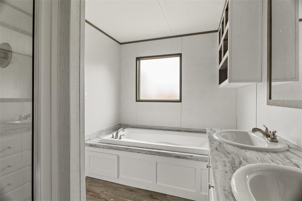 3606 Hilltop Road Granbury, TX 76048 - Photo 18 of 25 a bathroom with a granite countertop sink and a mirror