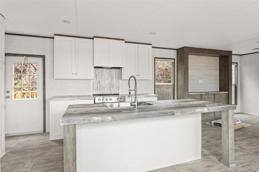 3606 Hilltop Road Granbury, TX 76048 - Photo 10 of 25 a kitchen with stainless steel appliances granite countertop a sink and a refrigerator