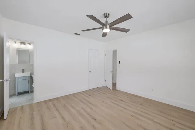 a view of a livingroom with wooden floor and a ceiling fan