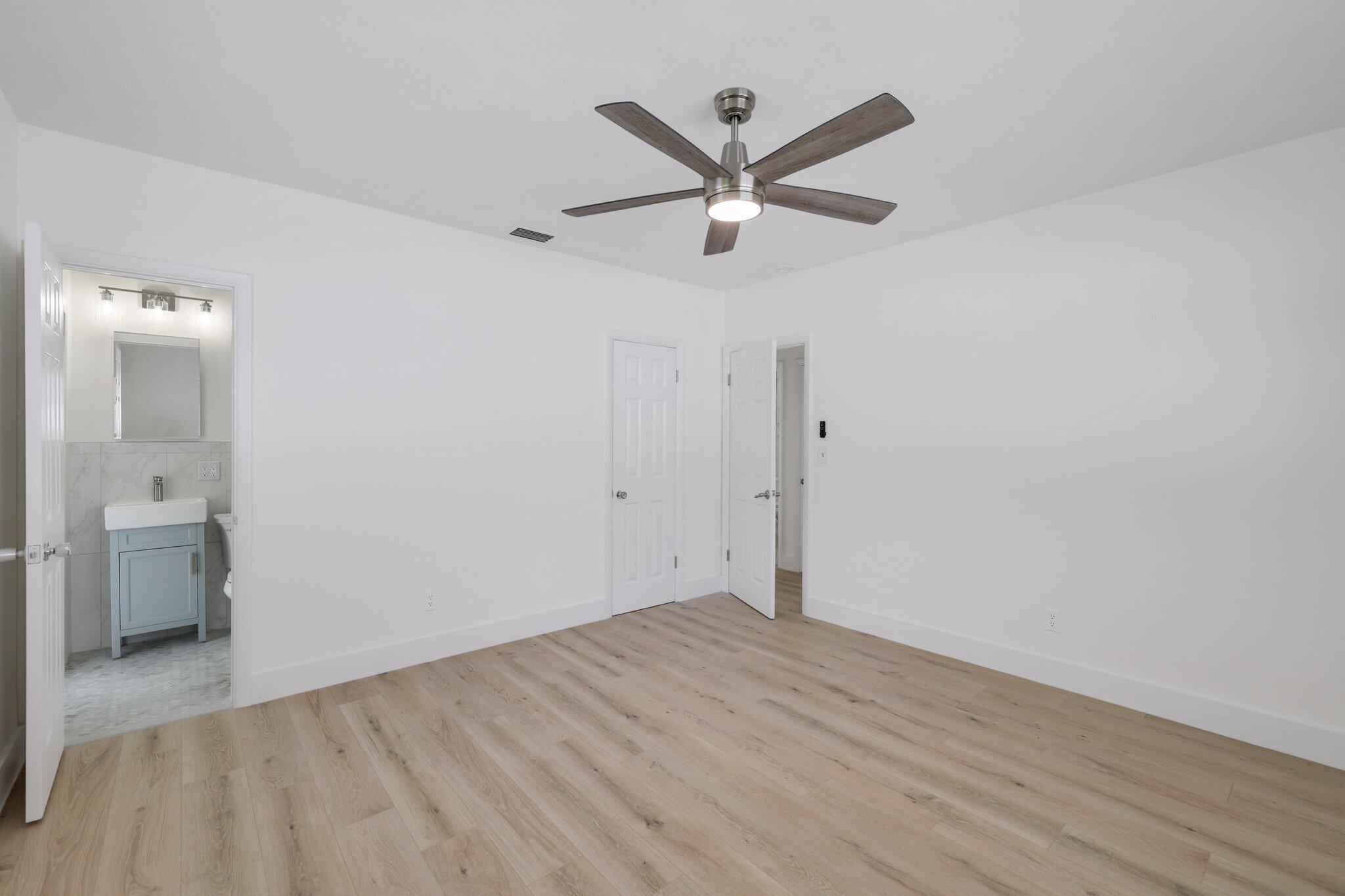 1198 Southwest 3rd Street Boca Raton, FL 33486 - Photo 21 of 29 a view of a livingroom with wooden floor and a ceiling fan