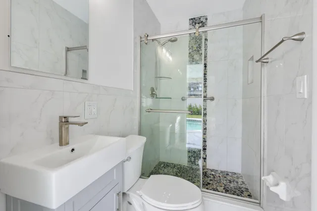 a bathroom with a sink toilet and shower