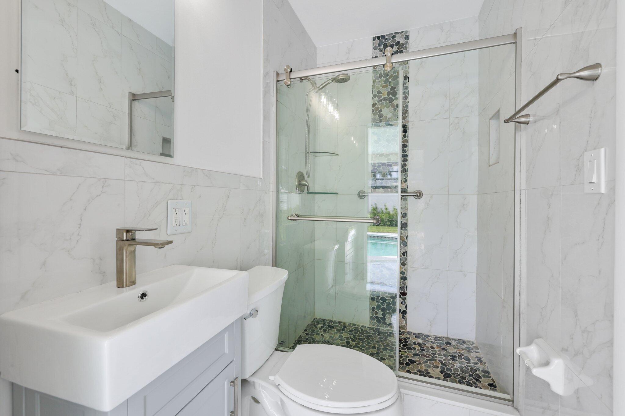 1198 Southwest 3rd Street Boca Raton, FL 33486 - Photo 22 of 29 a bathroom with a sink toilet and shower