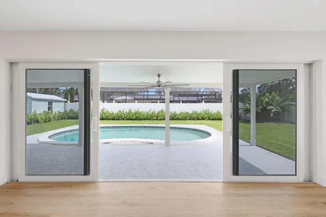 a view of a livingroom with a floor to ceiling window and stairs