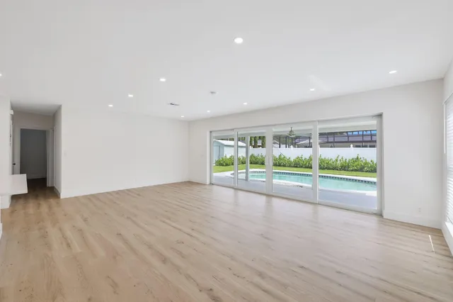 a view of room with wooden floor and window