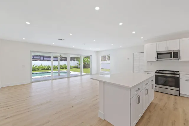 a kitchen with stainless steel appliances a stove sink and microwave