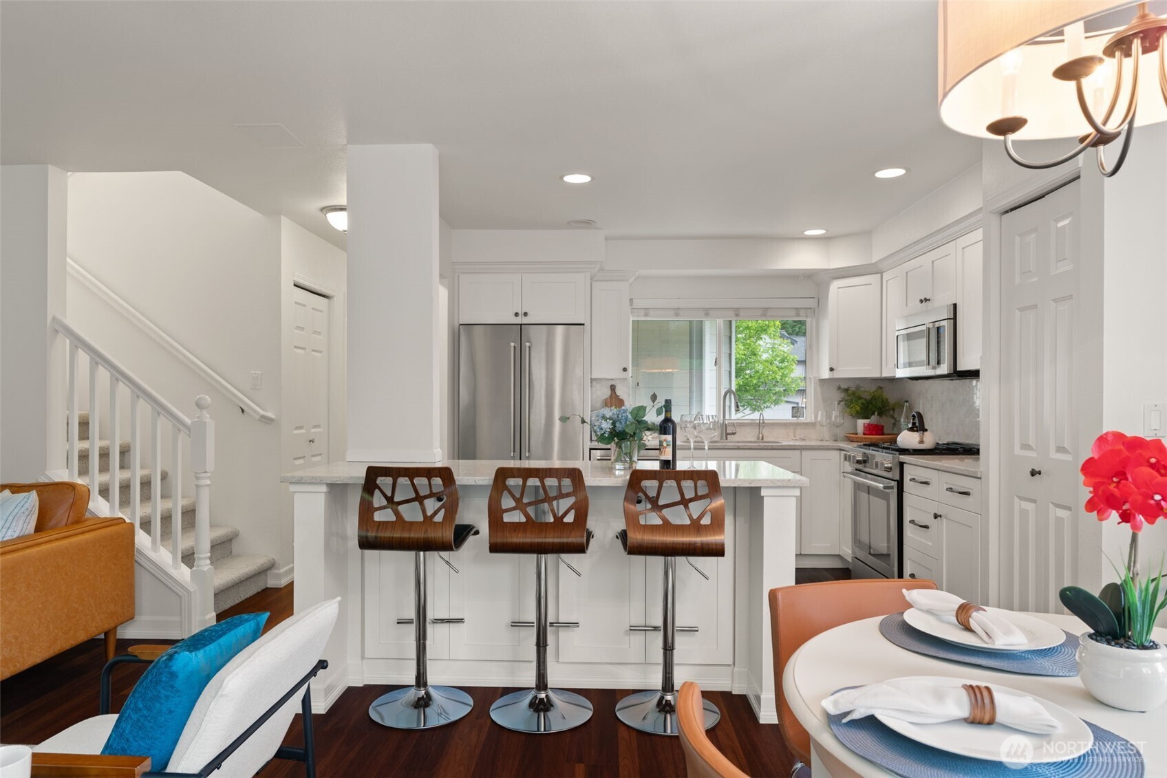 a kitchen with stainless steel appliances kitchen island granite countertop a sink and cabinets