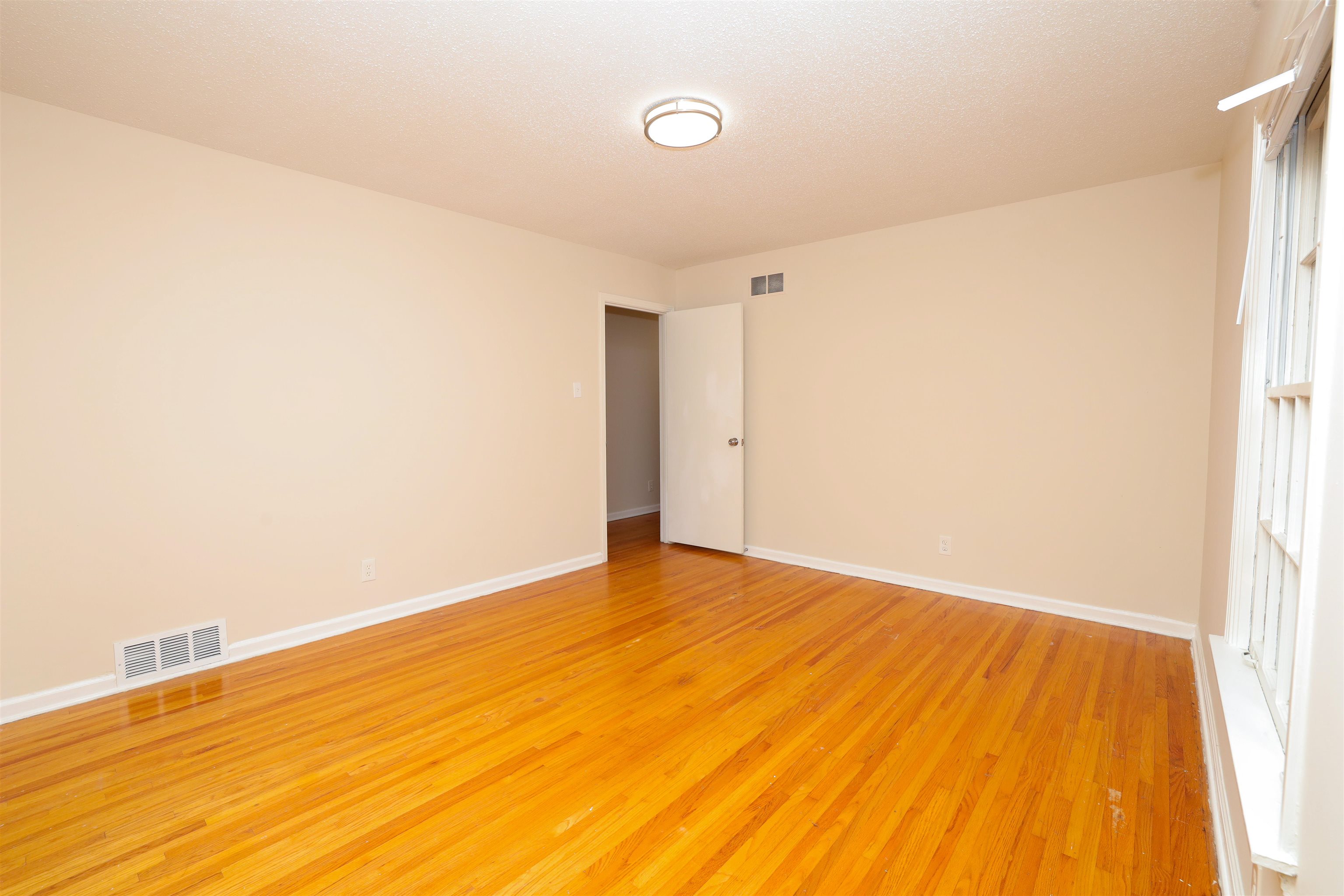 4843 Rolling Fields Drive Memphis, TN 38128 - Photo 11 of 22 Unfurnished room with hardwood / wood-style flooring