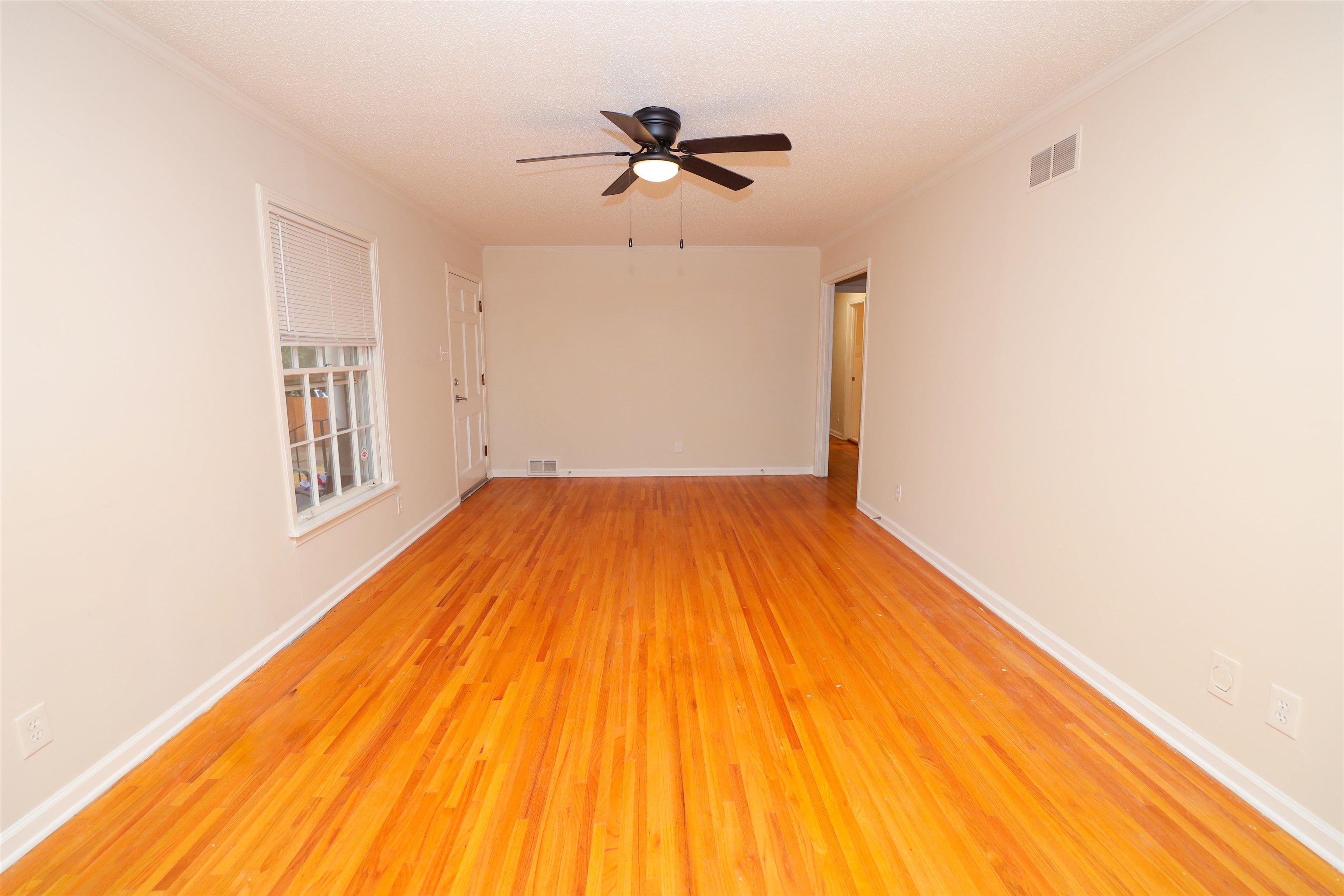 4843 Rolling Fields Drive Memphis, TN 38128 - Photo 5 of 22 Unfurnished room featuring crown molding, light hardwood / wood-style floors, and ceiling fan