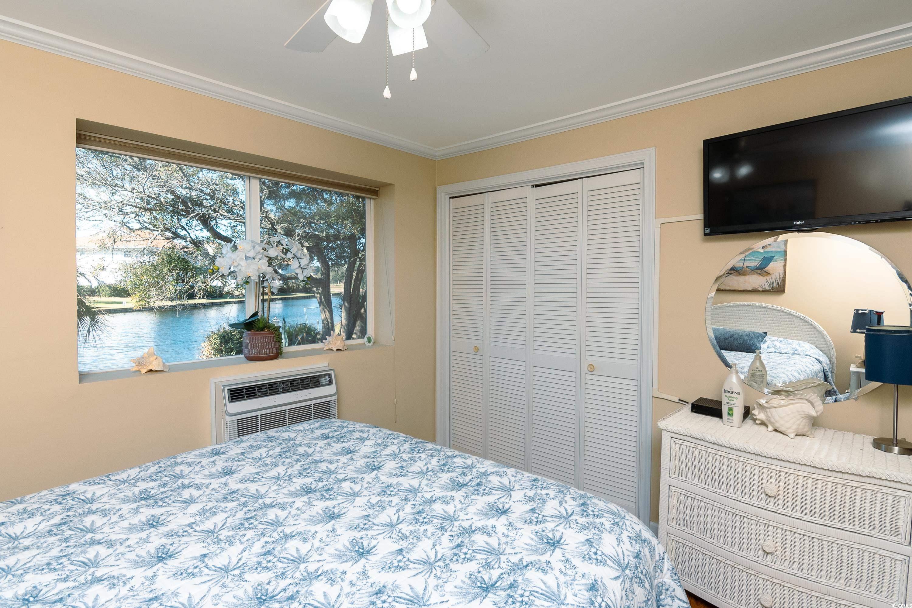 1919 Spring Street, Unit B16 North Myrtle Beach, SC 29582 - Photo 17 of 40 Bedroom featuring a closet, ornamental molding, an