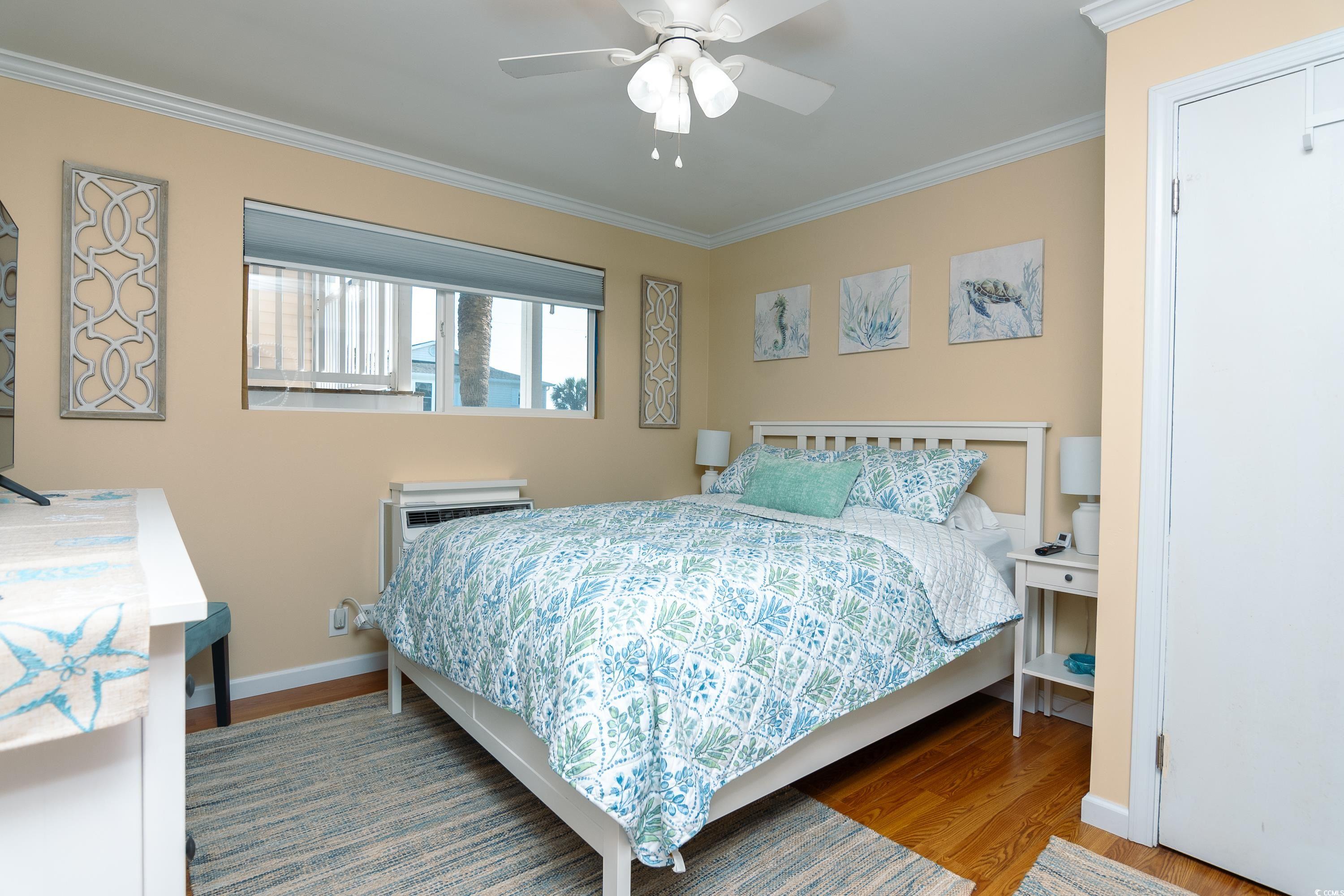 1919 Spring Street, Unit B16 North Myrtle Beach, SC 29582 - Photo 23 of 40 Bedroom with crown molding, a wall mounted air con