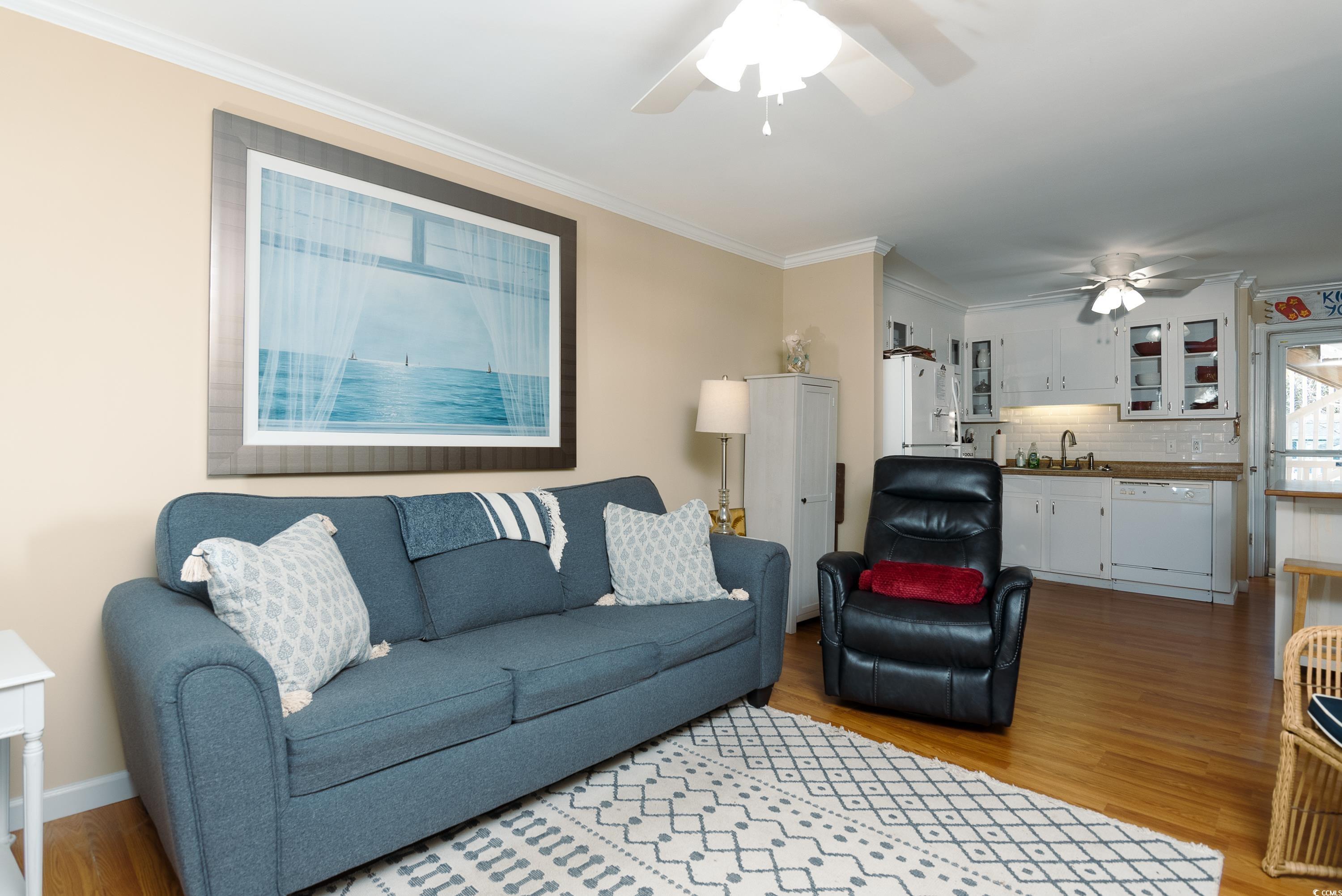 1919 Spring Street, Unit B16 North Myrtle Beach, SC 29582 - Photo 8 of 40 Living room with ornamental molding, sink, wood-ty