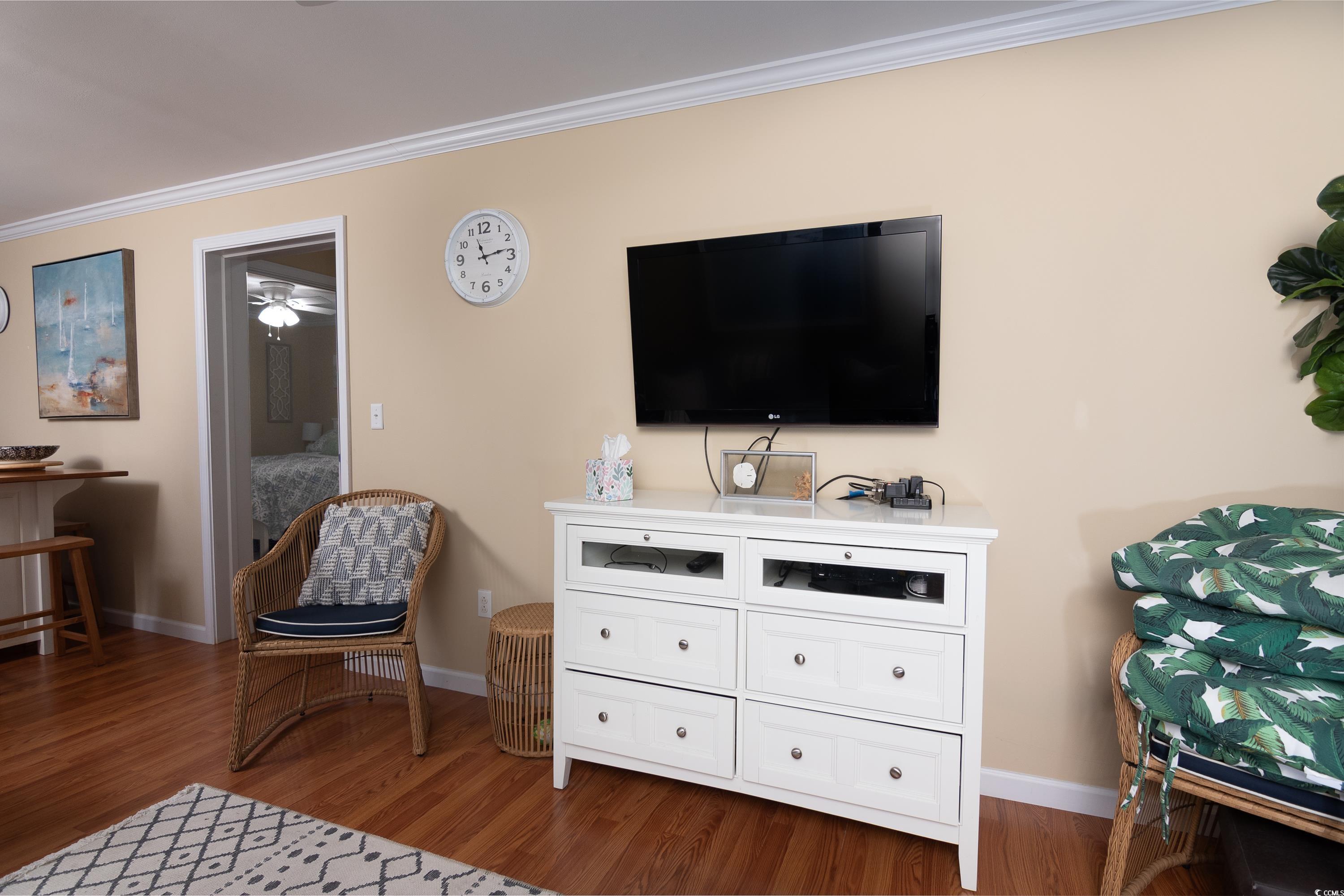 1919 Spring Street, Unit B16 North Myrtle Beach, SC 29582 - Photo 10 of 40 Sitting room with ceiling fan, ornamental molding,