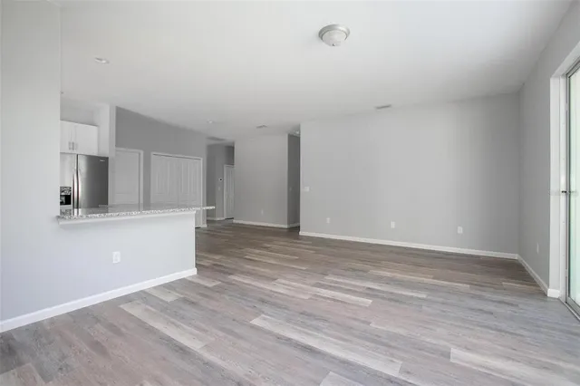 a view of a kitchen with wooden floor and a sink