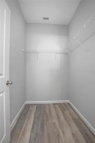 a view of a room with wooden floor