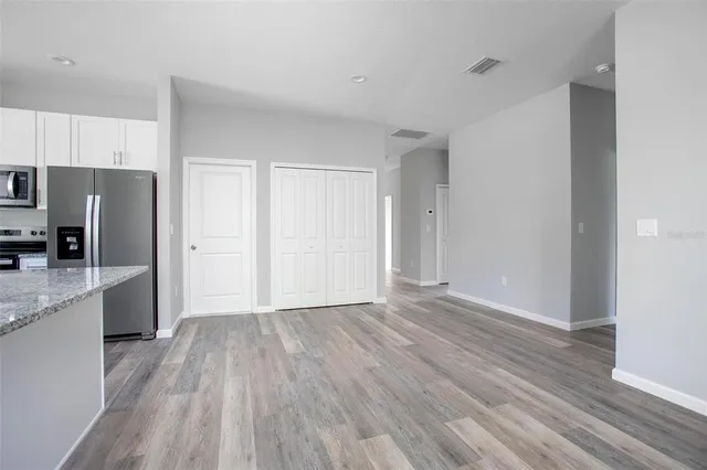a view of a kitchen with a sink and a refrigerator