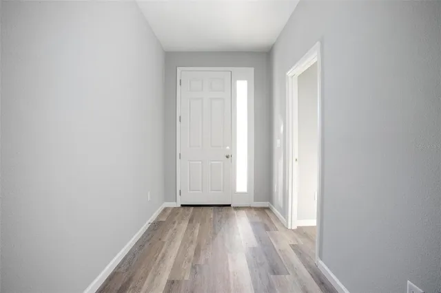 a view of a room with wooden floor