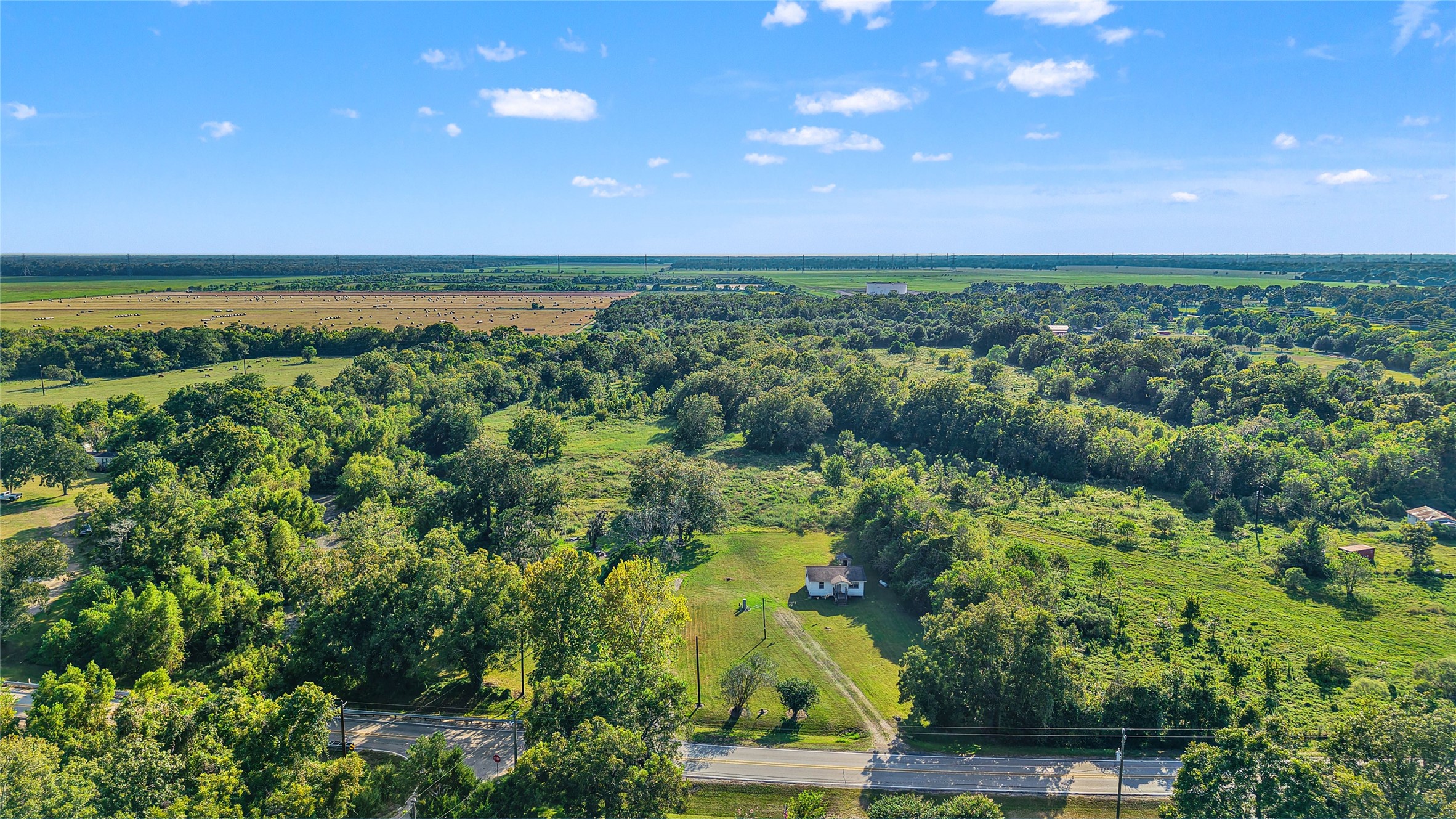 3014 Farm To Market 524 Road Sweeny, TX 77480 - Photo 5 of 18 The property borders Dance Bayou, where water levels can vary throughout the year, and offers privacy with no neighboring homes visible on either side or behind.