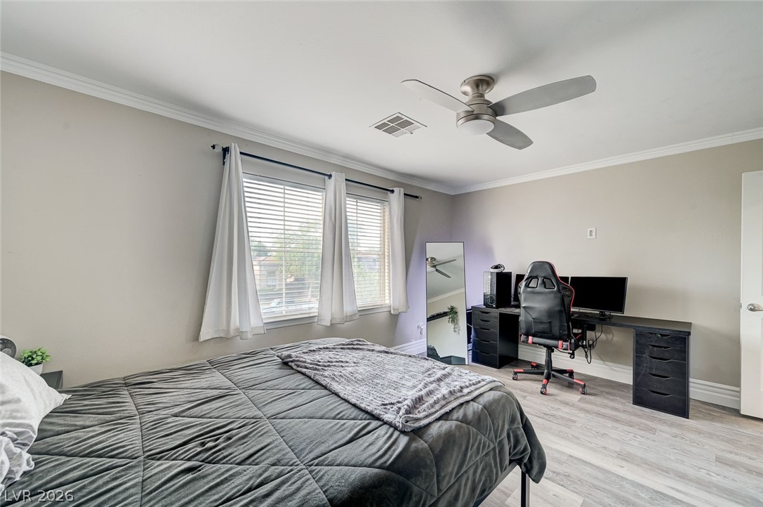 2391 Rainswept Avenue Henderson, NV 89052 - Photo 45 of 62 This serene bedroom offers ample light and modern finishes, perfect for relaxation.