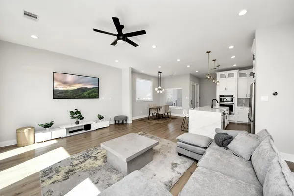 a bedroom with a large bed and a chandelier