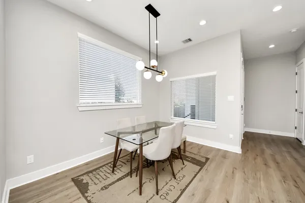a bathroom with a double vanity sink a mirror and a toilet