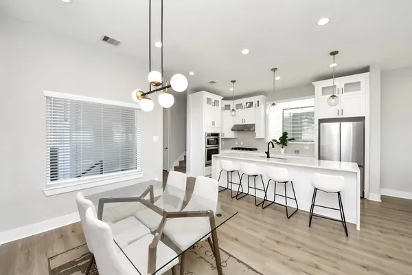 a living room with a bed furniture and a wooden floor