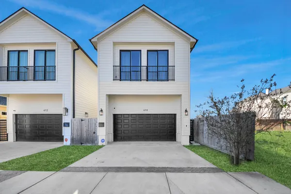 a living room with furniture and a kitchen view