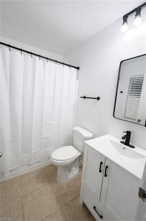 5424 16th Place Southwest, Unit C3 Naples, FL 34116 - Photo 6 of 7 a bathroom with a sink a toilet and mirror