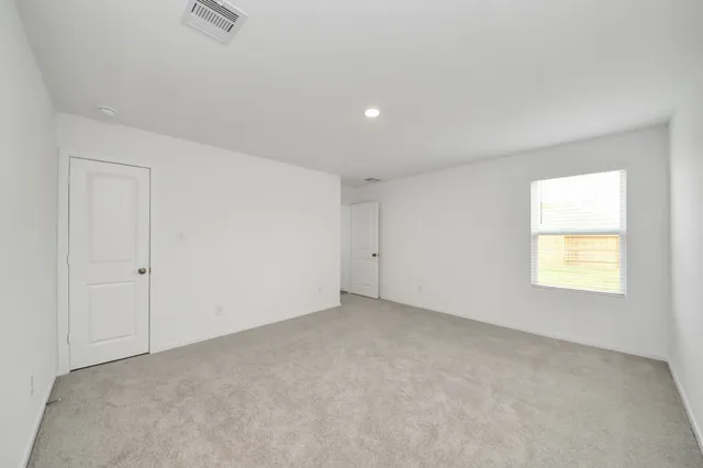 a view of an empty room and a window