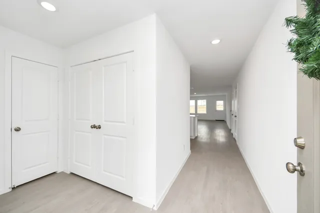 a view of a hallway with wooden floor