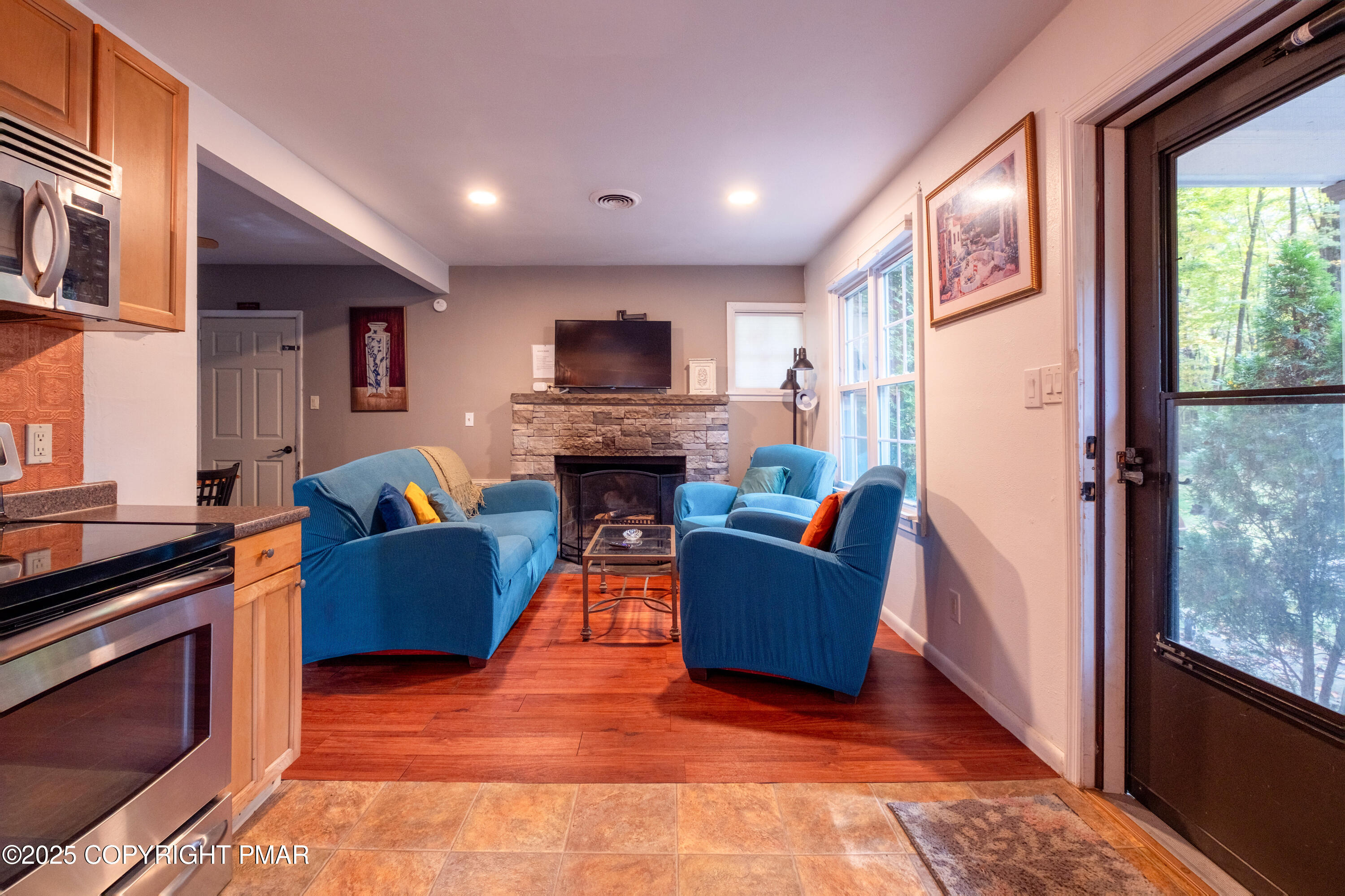 1885 Sullivan Trail Tannersville, PA 18372 - Photo 11 of 46 a living room with furniture a fireplace and a flat screen tv