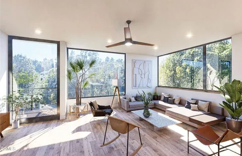 a dining room with furniture potted plants and wooden floor