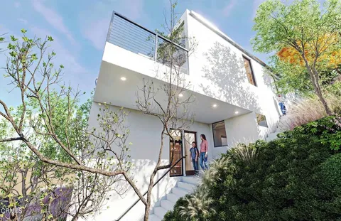 a bedroom with furniture and a large window