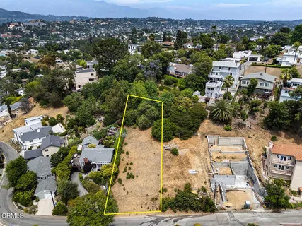 an aerial view of residential houses with outdoor space
