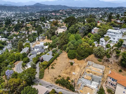 an aerial view of residential houses with outdoor space