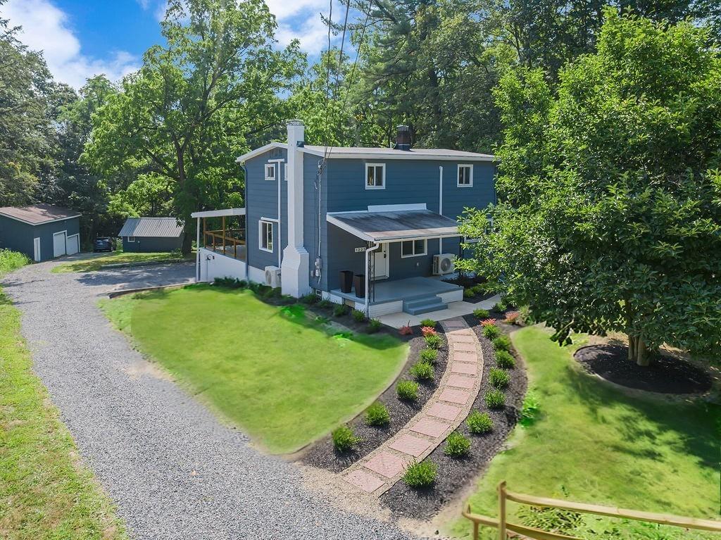 a view of a house with a backyard porch and sitting area