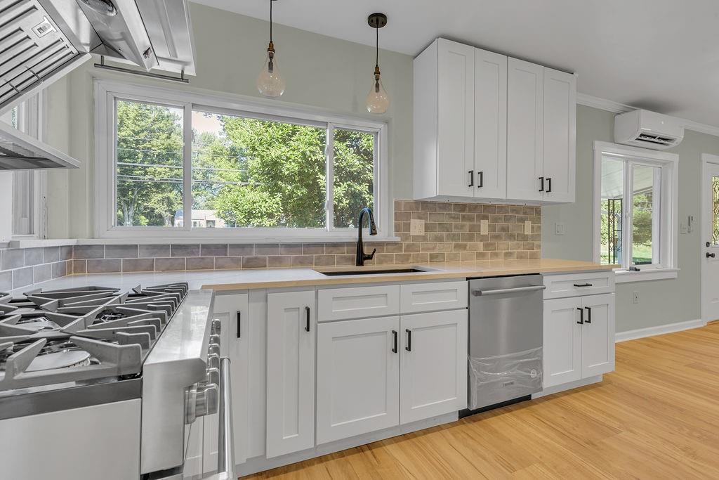 1225 Lovi Road Freedom, PA 15042 - Photo 11 of 41 a kitchen with stainless steel appliances granite countertop a sink stove and cabinets
