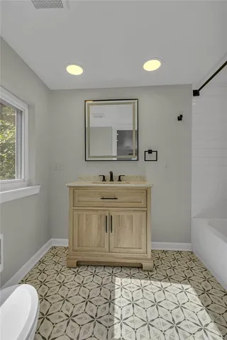 a bathroom with a sink vanity and mirror
